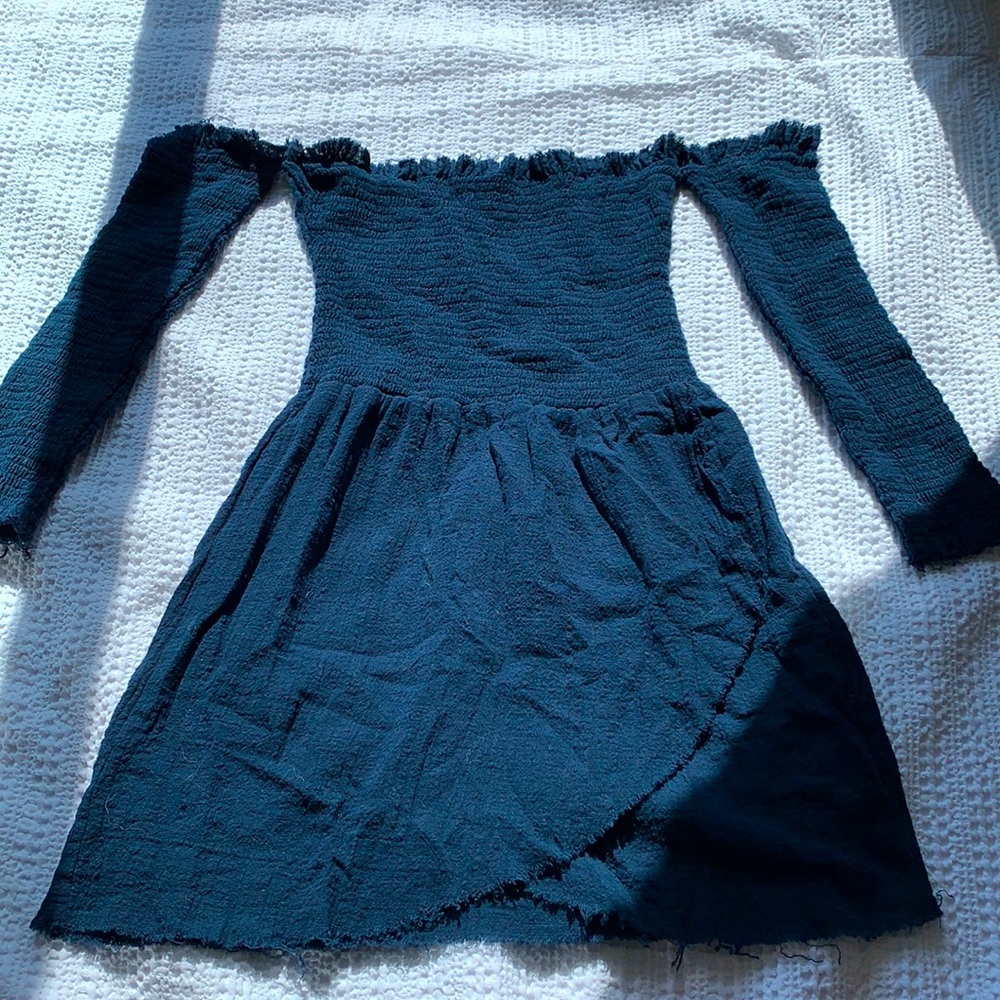 Off the shoulder with connecting sleeves.